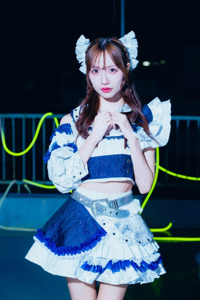 アイドルグループNEFRALISE(ネフラリゼ)の八咲実夢。青と白の2nd衣装を着用し、ネオンが光る夜に立つ、2ndシングル時のアーティスト写真。